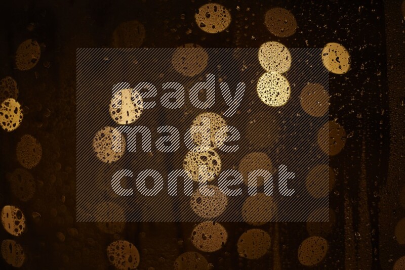 Bokeh light in yellow with water drops
