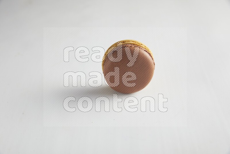 45º Shot of Yellow and Brown Chai Latte macaron on white background