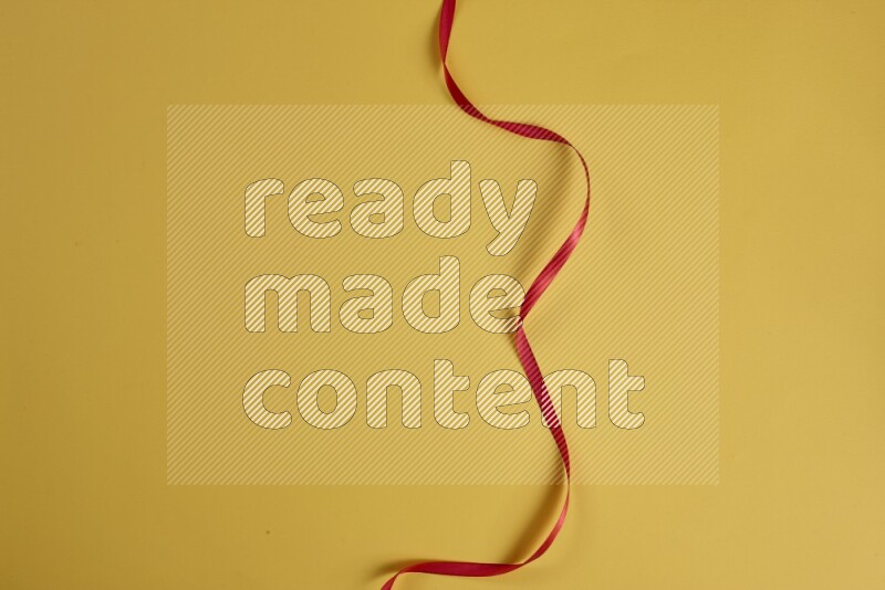 A red collection of sewing and tailoring tools arranged on a yellow background