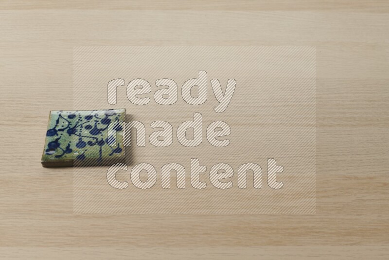 A decorative coaster on light wooden background