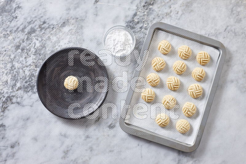 Kahk step by step with its ingredients ghee, sugar, flour, sesame, yeast, water and kahk flavor on grey marble background