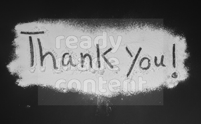 A sentence written with powder on black background