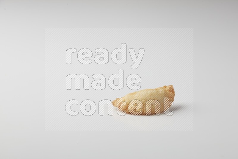 One fried sambosa on a white background
