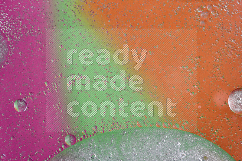 Close-ups of abstract oil bubbles on water surface in shades of orange, green and pink