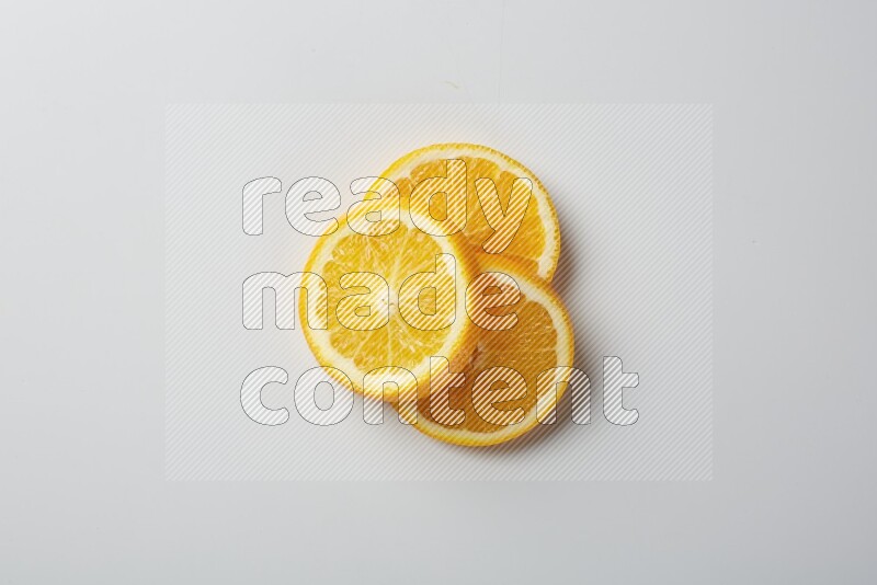 Three orange slices on a white background