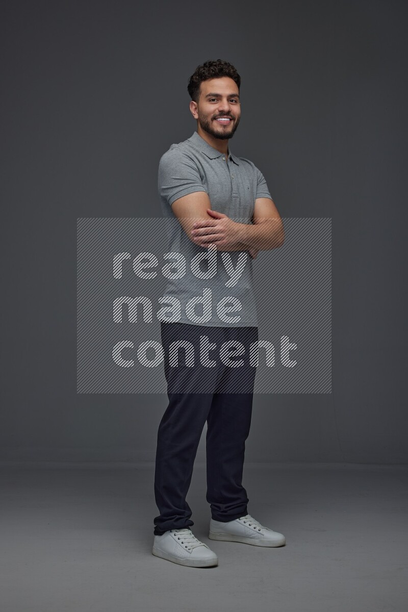 A man wearing casual making multi stand poses  eye level on a gray background