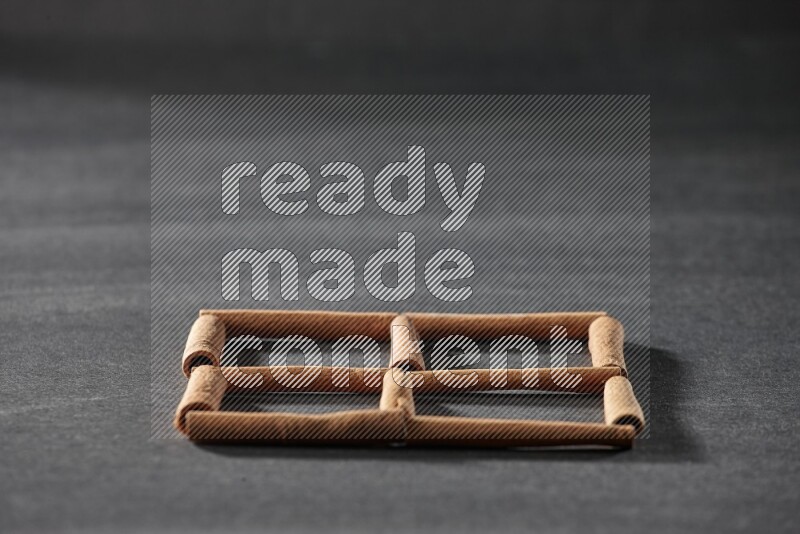 4 squares of cinnamon sticks on black flooring