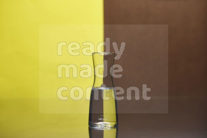 The image features a clear glassware filled with water, set against yellow and brown background