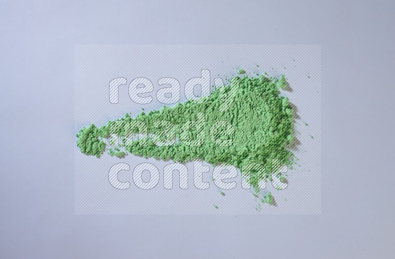 Green powder smears on white background