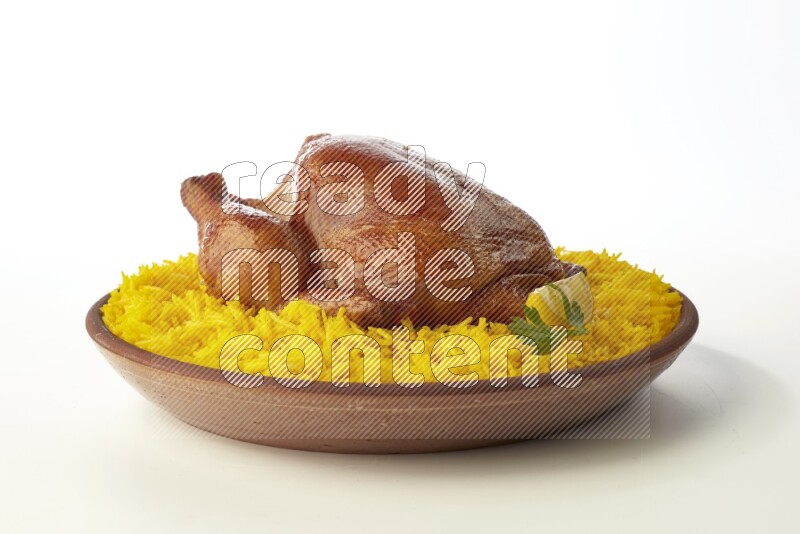yellow basmati Rice with whole roasted chicken  on a pottery plate  direct  on white background