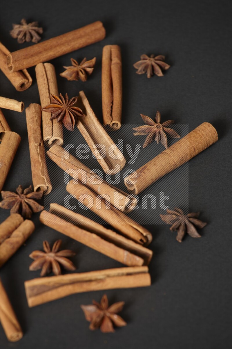 Cinnamon sticks and star anise on black background