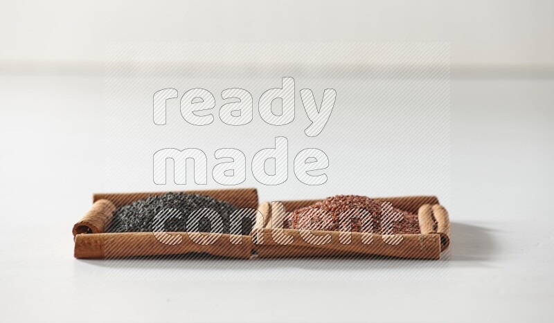 2 squares of cinnamon sticks full of black seeds and garden cress on white flooring