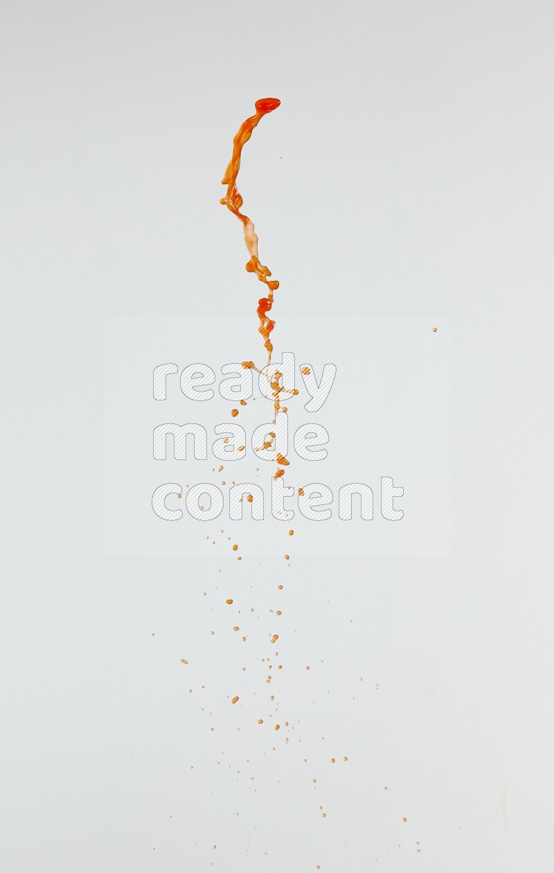 Orange liquid splash and drops on white background
