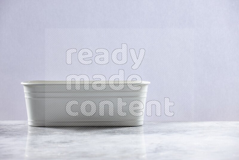 An empty white plant pot on grey marble background