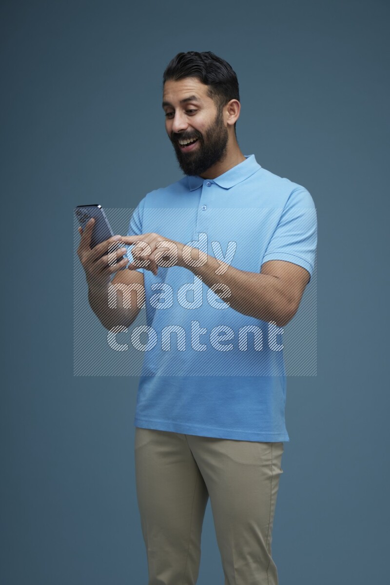 A man Swiping in a blue background wearing a Blue shirt