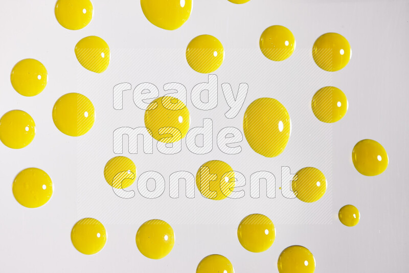 Close-ups of abstract yellow paint droplets on white background