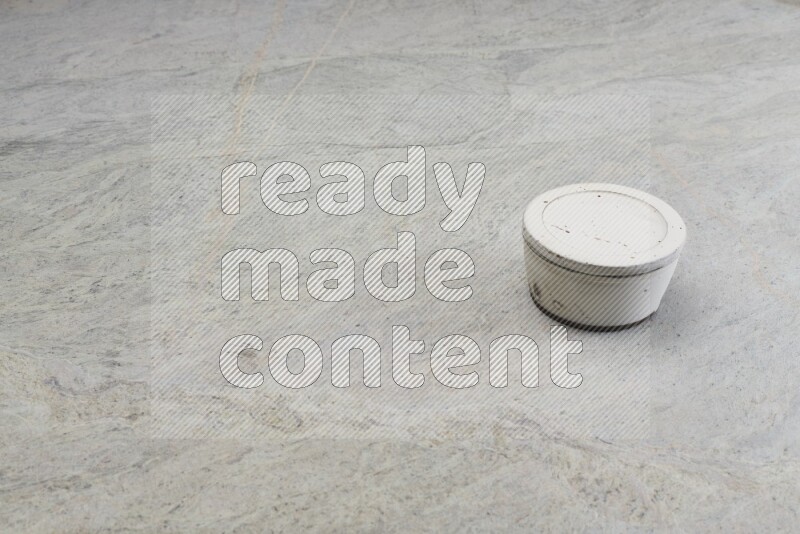 A white pottery bowl on grey marble background