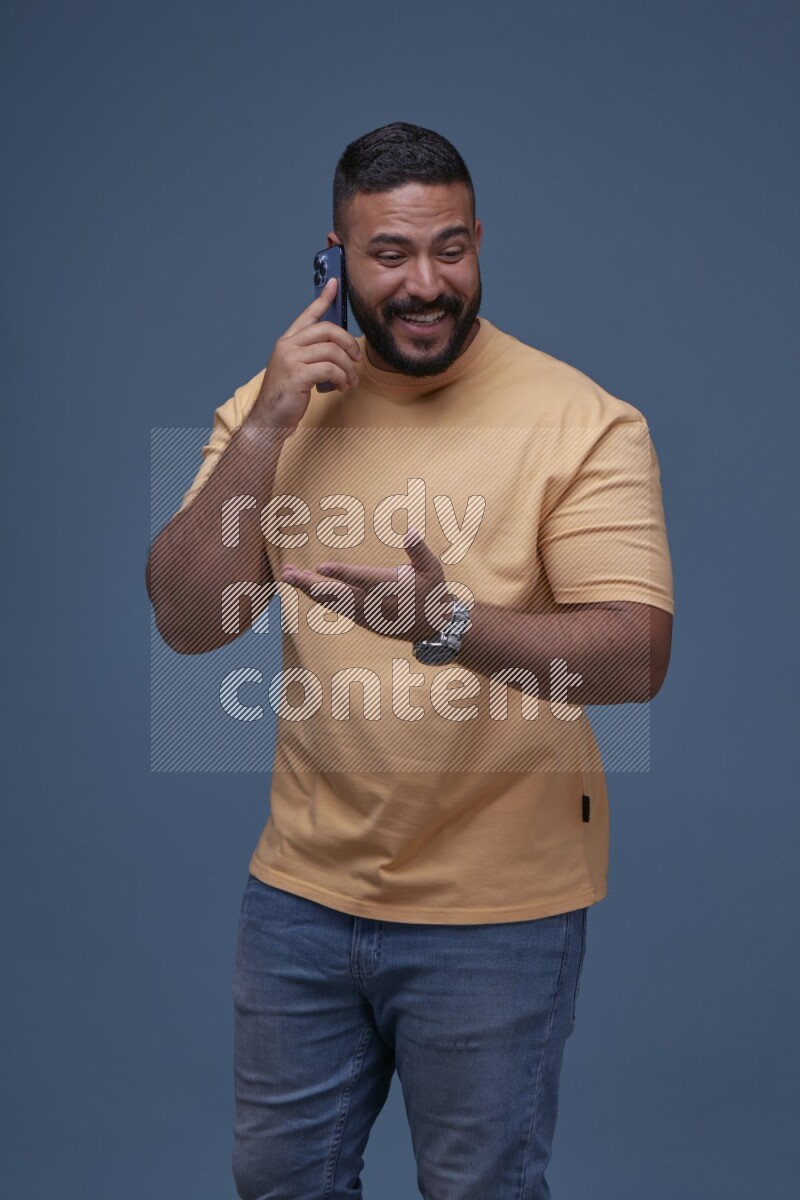 A man Calling on Blue Background wearing Orange T-shirt