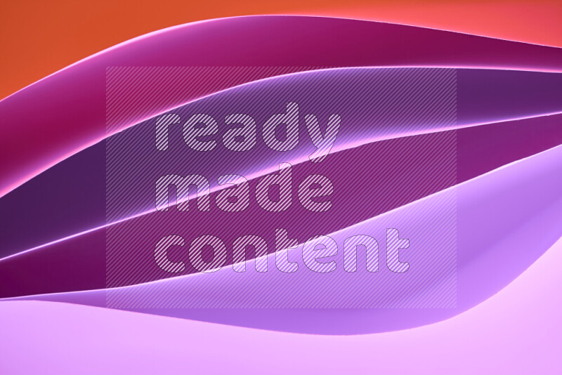 This image showcases an abstract paper art composition with paper curves in different warm gradients created by colored light