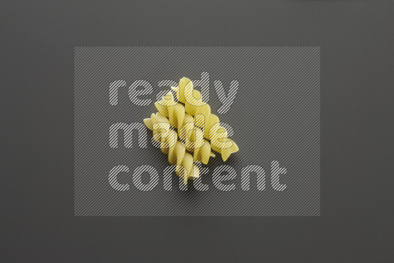 Fusilli pasta on grey background
