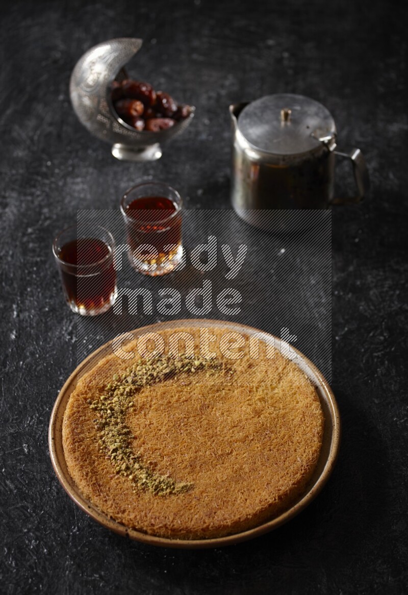 konafa with tea in a dark setup
