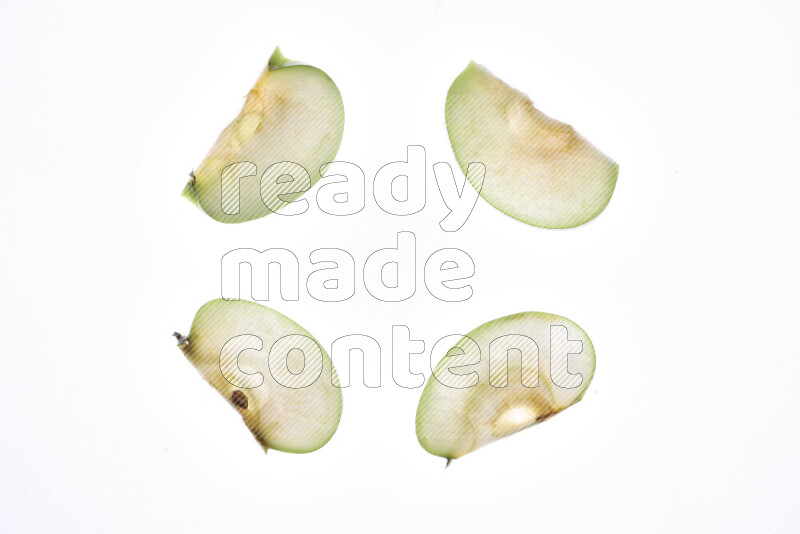 Apple slices on illuminated white background