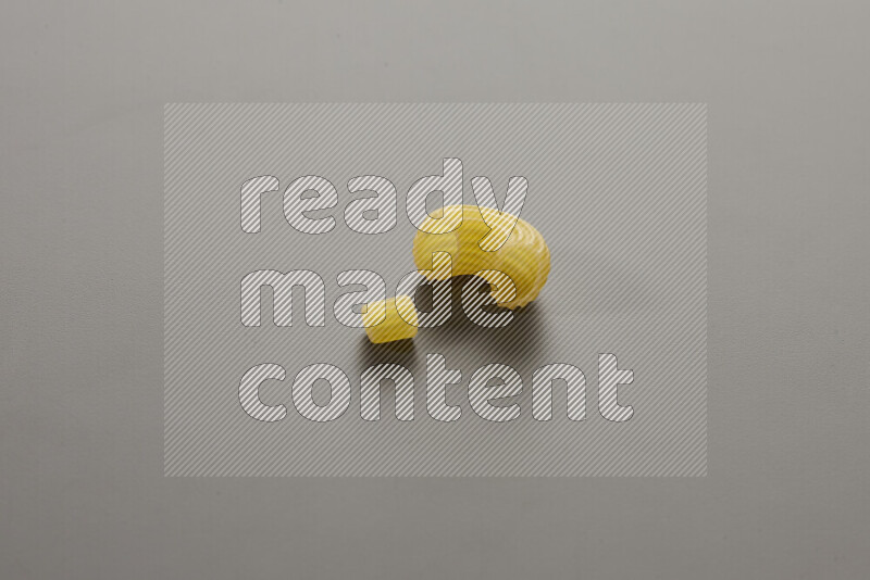 Small rings pasta with other types of pasta on grey background
