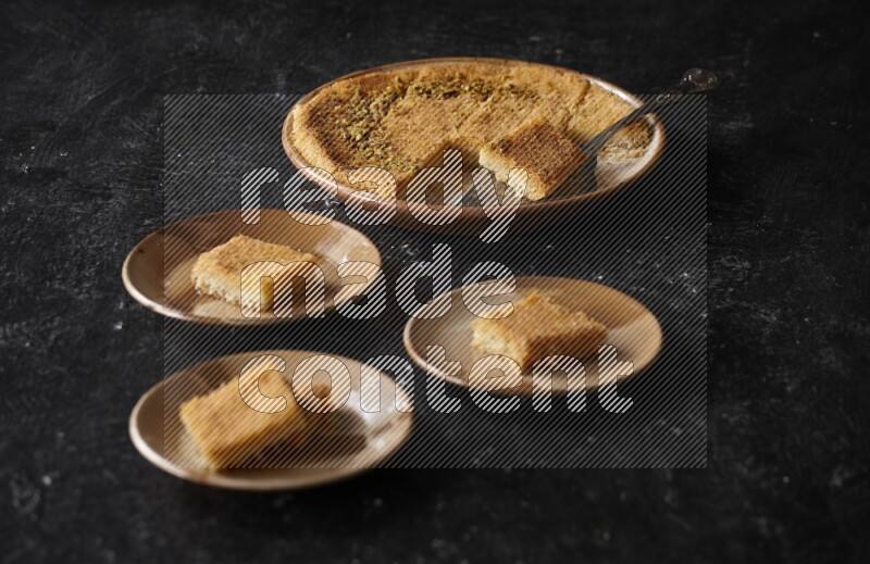 Konafa in different plates in a dark setup