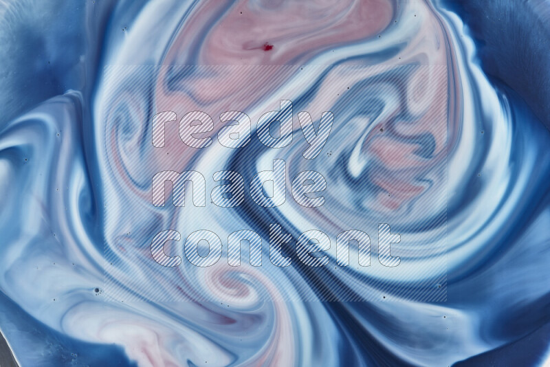 A close-up of abstract swirling patterns in blue, red and white