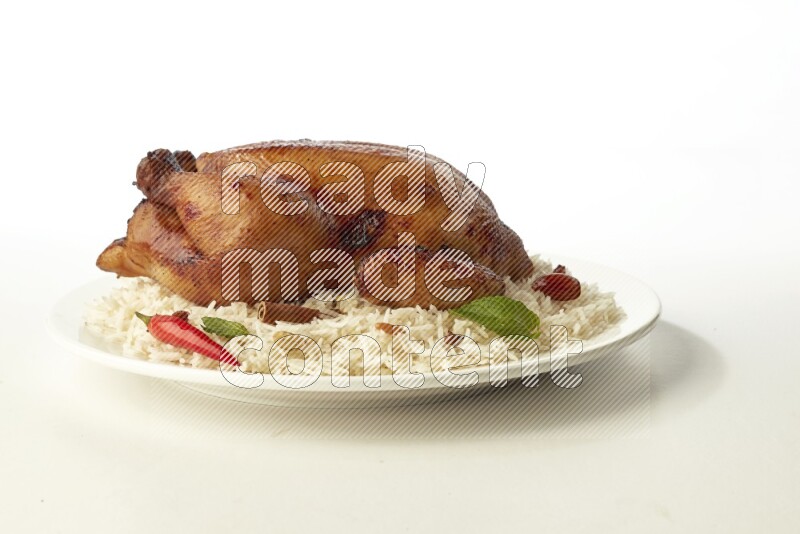 white  basmati Rice with  whole roasted chicken  on a white rounded plate direct on white background