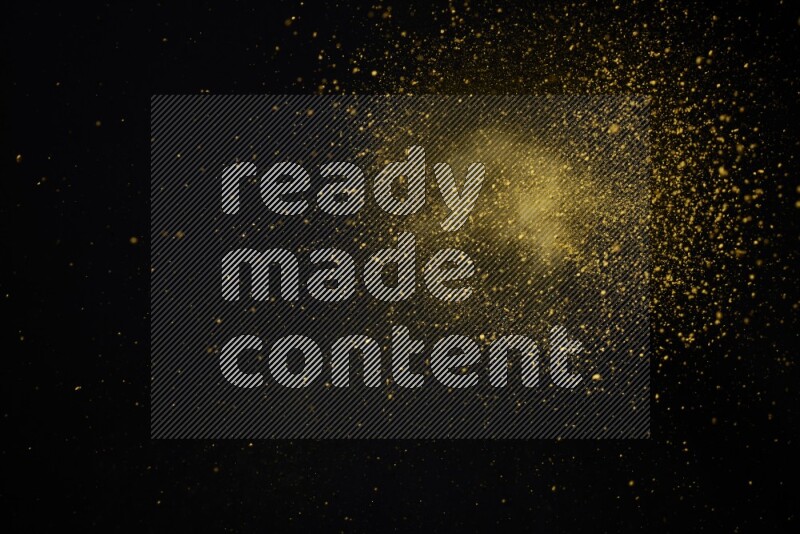 Yellow powder explosion on black background
