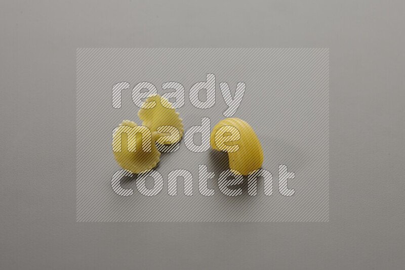 Fiocchi pasta with other types of pasta on grey background