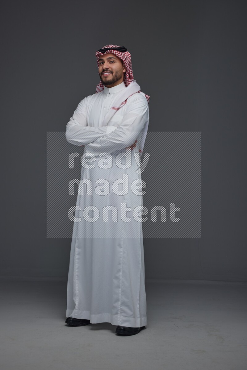 A Saudi man wearing Thobe and Shmagh standing in different poses eye level on a gray background