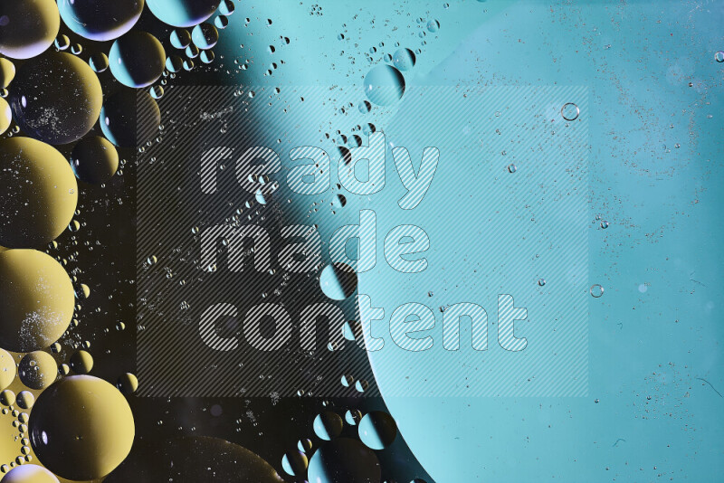 Close-ups of abstract oil bubbles on water surface in shades of green, black and yellow