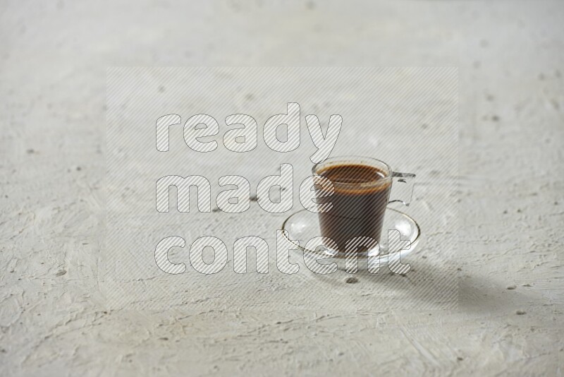 A coffee glass cup with dates and tea on textured white background