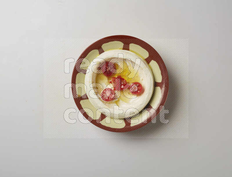 Lebnah garnished with Cherry tomato in a traditional plate on a white background