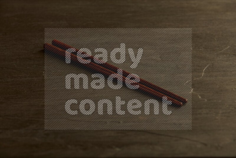 wooden chopsticks on black slate background