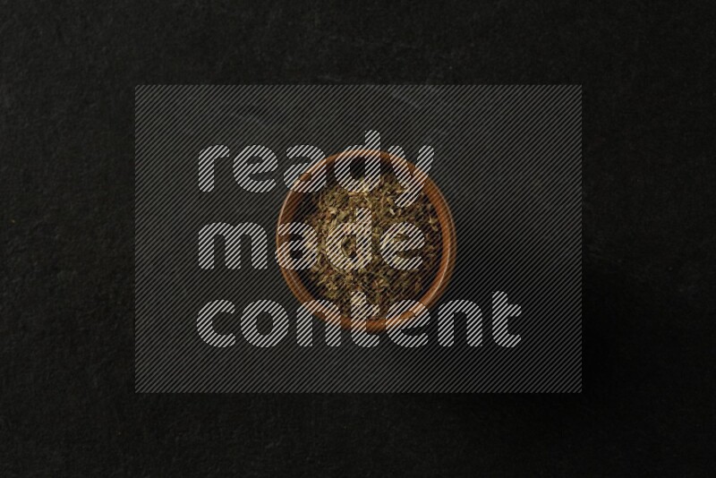 multi color round sauce bowl filled with herbs on grey textured countertop