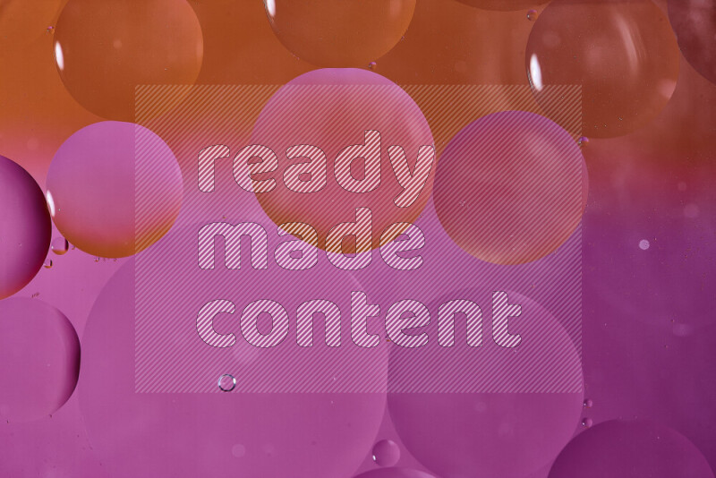 Close-ups of abstract oil bubbles on water surface in shades of orange and pink