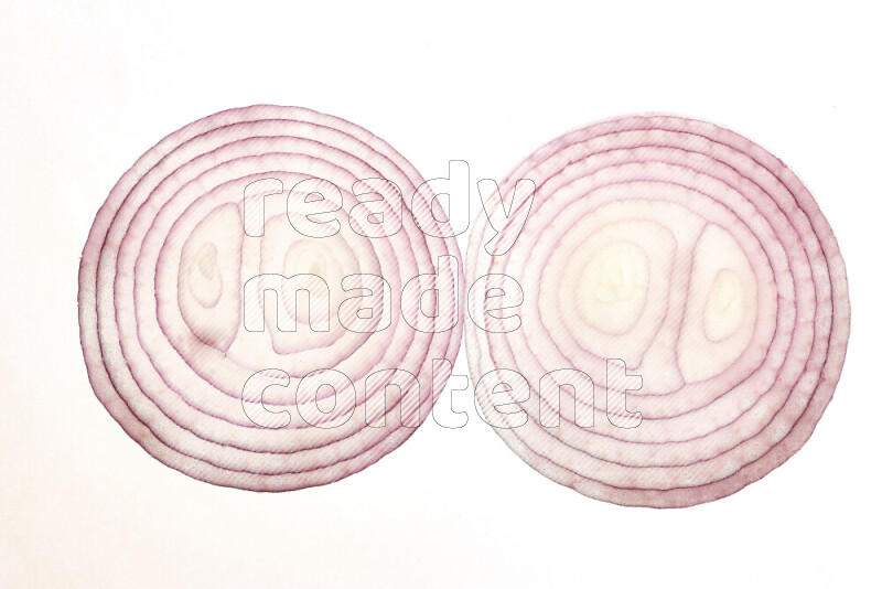 Onion slices on illuminated white background