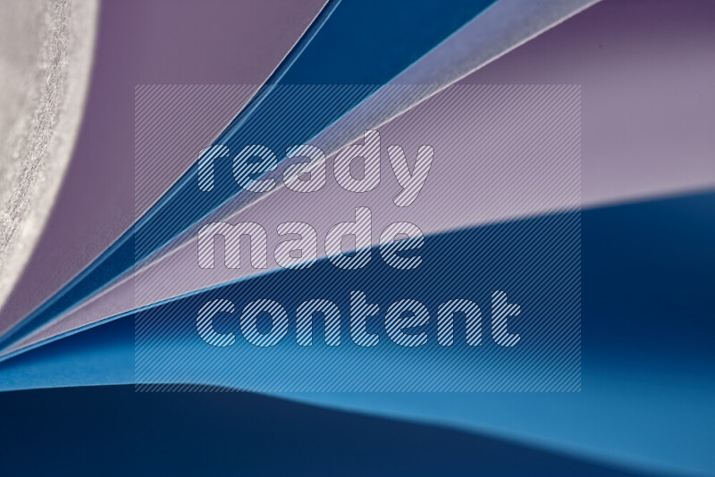 An abstract art showing purple and blue paper sheets arranged in an overlapping curves