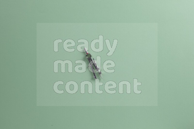 Different school supplies on green background