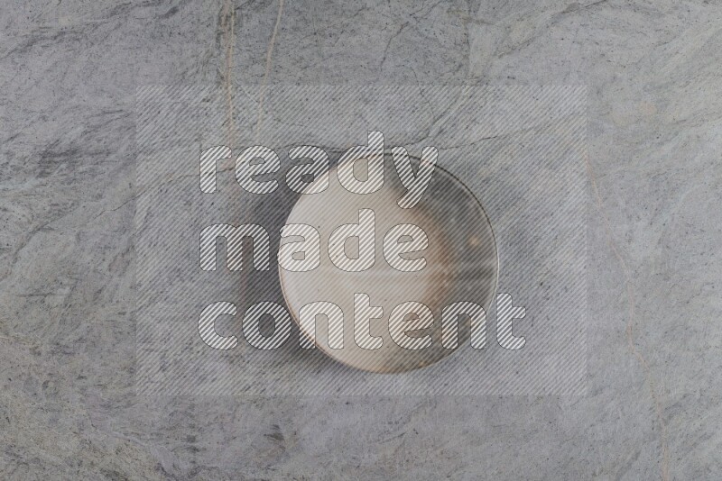 A multicolored pottery plate on grey marble background