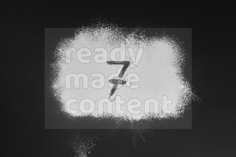 Numbers written with powder on black background