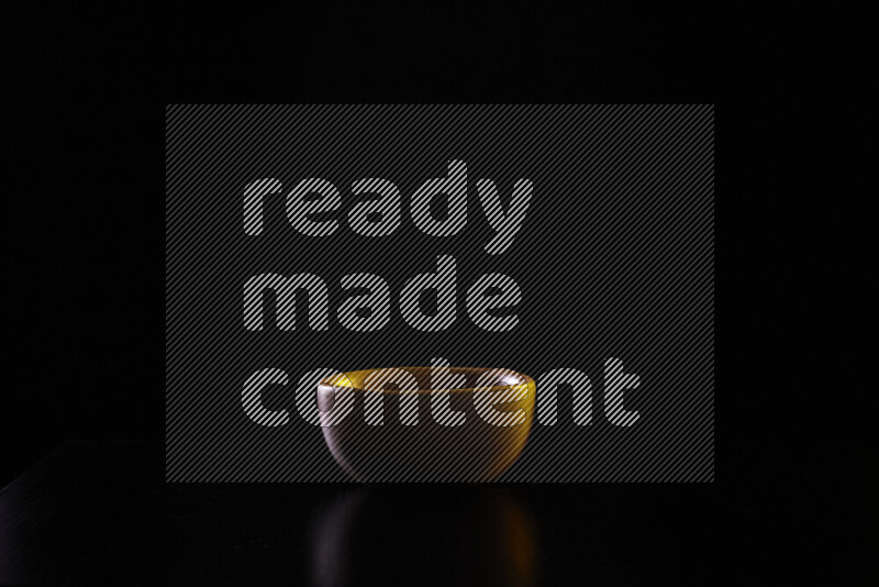 Wooden kitchen essentials with colored rim light against black background