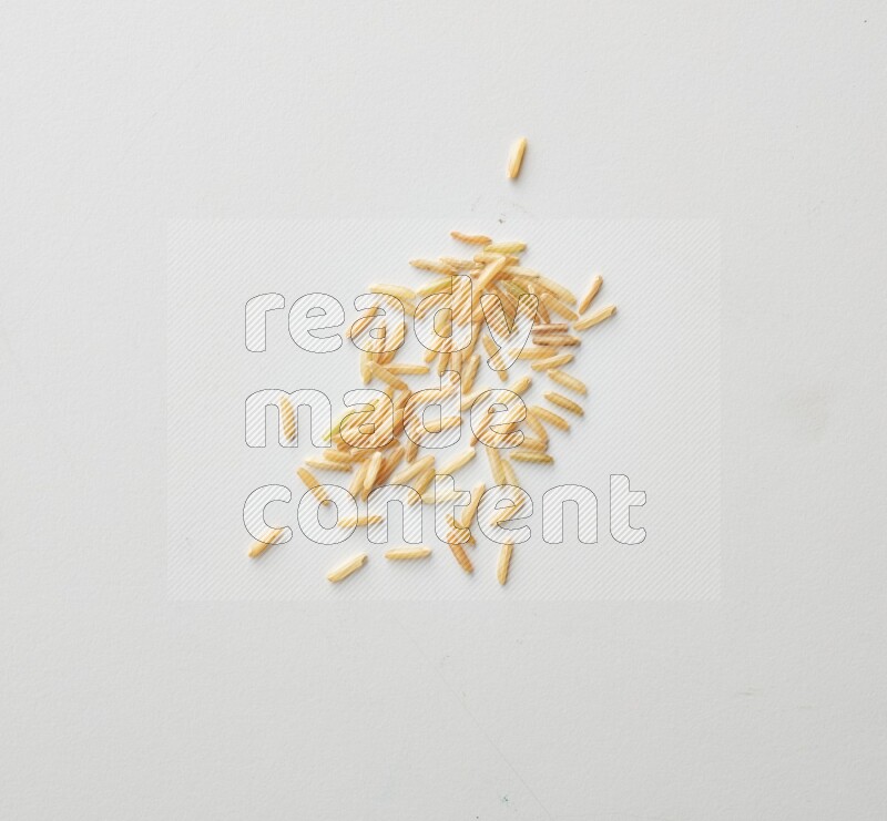 Top-view shot of long grain brown rice on white background