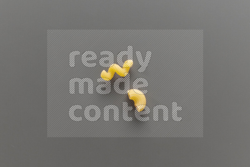 Twist pasta with other types of pasta on grey background