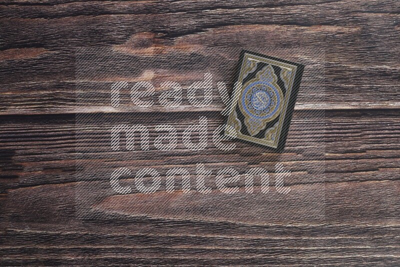 Quran with a prayer beads on wooden background