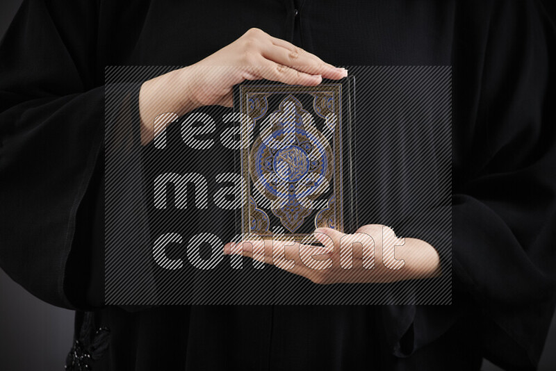 A woman hands holding moshaf in different positions