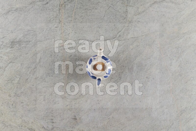 A pottery teapot on grey marble background